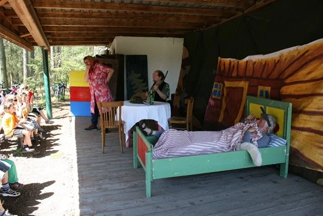 Loutkové divadlo s postavou ležící v posteli pod přístřeškem